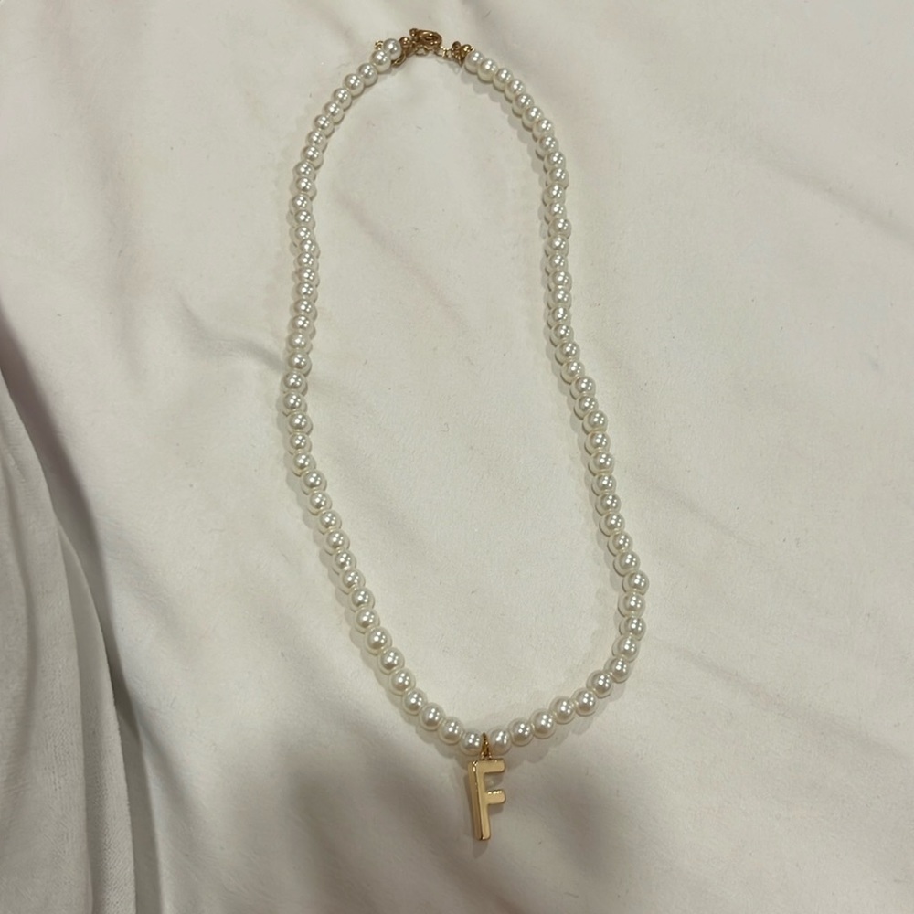Pearl necklace letter F